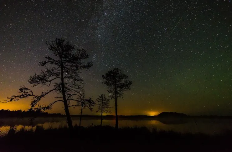 A Perseid meteor streaking over the Milky Way during a meteor shower